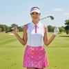 Woman wearing metallic pink active skort while playing golf, showing comfortable movement and UV-protective fabric. 
Women’s White & Pink Active Polo – Stylish Golf, Tennis & Pickleball Shirt