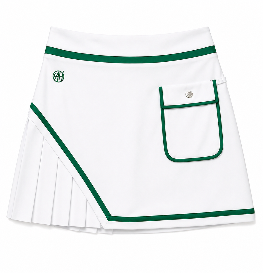 Luxury women’s golf skort in white with Kelly green trim. Built-in shorts with pockets, tee holders, and premium performance fabric.
