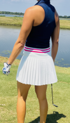 Model wearing Sarah Flair Skort — elegant, flowy luxury skort for movement and performance on the golf course, tennis court, or daily wear. High Waisted band. White Pink and Navy 