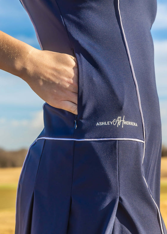 Women’s Navy & White Stripe Active Dress — luxury performance dress for golf, tennis, and pickleball with a flattering modern fit and comfortable movement. Hidden side pockets. Detailed piping. 