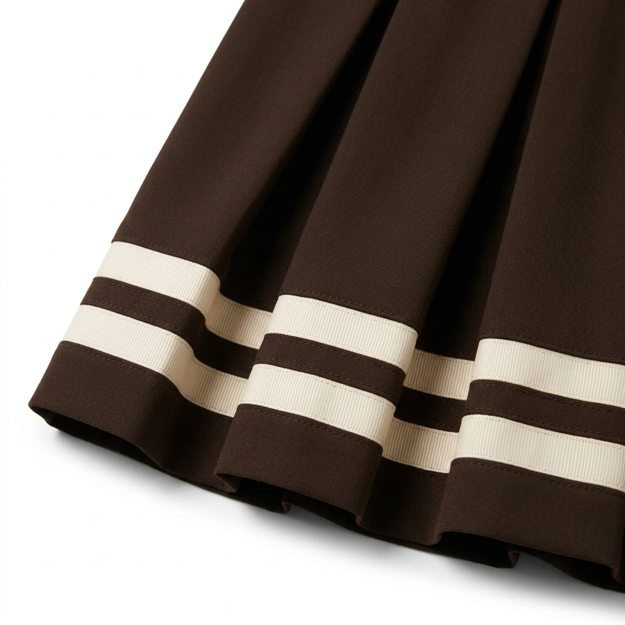 Brown Charlotte skirt with cream ribbon detail and wider pleats